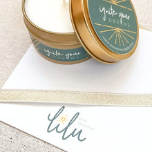 Load image into Gallery viewer, A hand-poured soy candle titled "Ignite Your Dreams" from the "Best Gal" gift box. Also included are a heartfelt greeting card titled "She was made of Sunlight," vibrant Ray of Sunshine Lemondrops, a charming coffee mug, and mini inspirational quote cards, creating a delightful and inspiring gift ensemble
